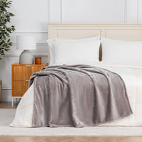 Premium VelvetLoft® Throw in Wild Dove, draped across the foot of a bed