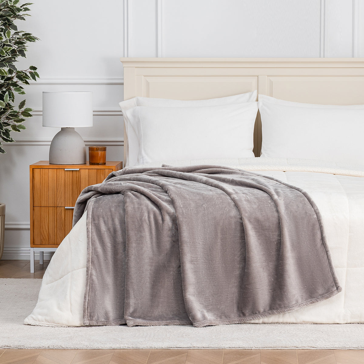 Premium VelvetLoft® Throw in Wild Dove, draped across the foot of a bed