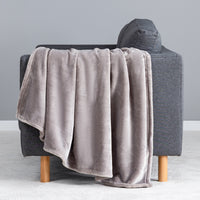 Premium VelvetLoft® Throw in Wild Dove, draped over the arm of a gray sofa, close view
