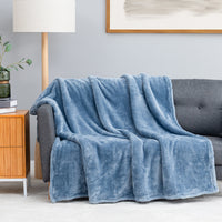 Premium Extra-Fluffy™ Throw in Arona draped over a gray sofa in a living room