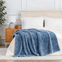 Premium Extra-Fluffy™ Throw in Arona draped across the foot of a bed