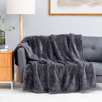 Premium Extra-Fluffy™ Throw in Castle Rock draped over a gray sofa in a living room