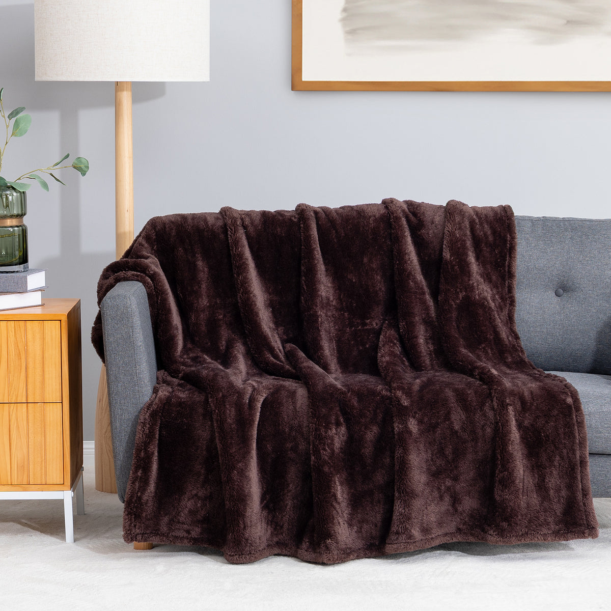 Premium Extra-Fluffy™ Throw in Coffee Brown draped over a gray sofa in a living room