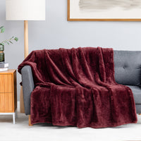 Premium Extra-Fluffy™ Throw in Deep Fig draped over a gray sofa in a living room