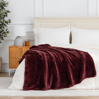 Premium Extra-Fluffy™ Throw in Deep Fig draped across the foot of a bed