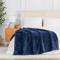 Premium Extra-Fluffy™ Throw in Dress Blue draped across the foot of a bed