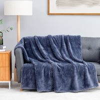Premium Extra-Fluffy™ Throw in Galaxy Blue draped over a gray sofa in a living room