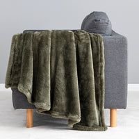 Premium Extra-Fluffy™ Throw in Ivy draped over the arm of a gray sofa, close view