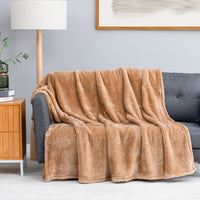 Premium Extra-Fluffy™ Throw in Prosecco draped over a gray sofa in a living room