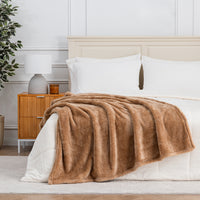 Premium Extra-Fluffy™ Throw in Prosecco draped across the foot of a bed