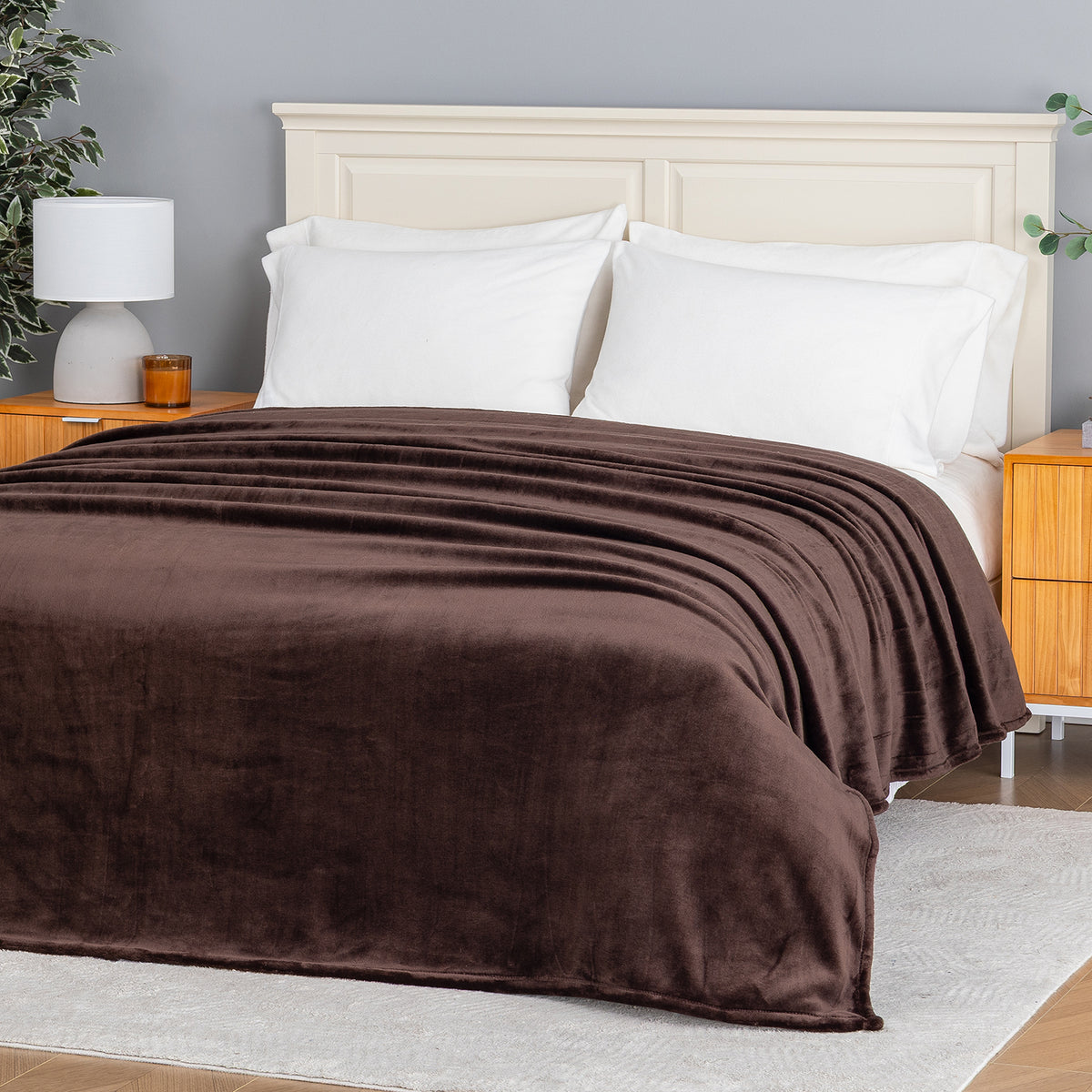 Premium VelvetLoft® Blanket in Colt on a made bed, angled view
