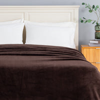 Premium VelvetLoft® Blanket in Colt across the foot of a made bed with white pillows, close view