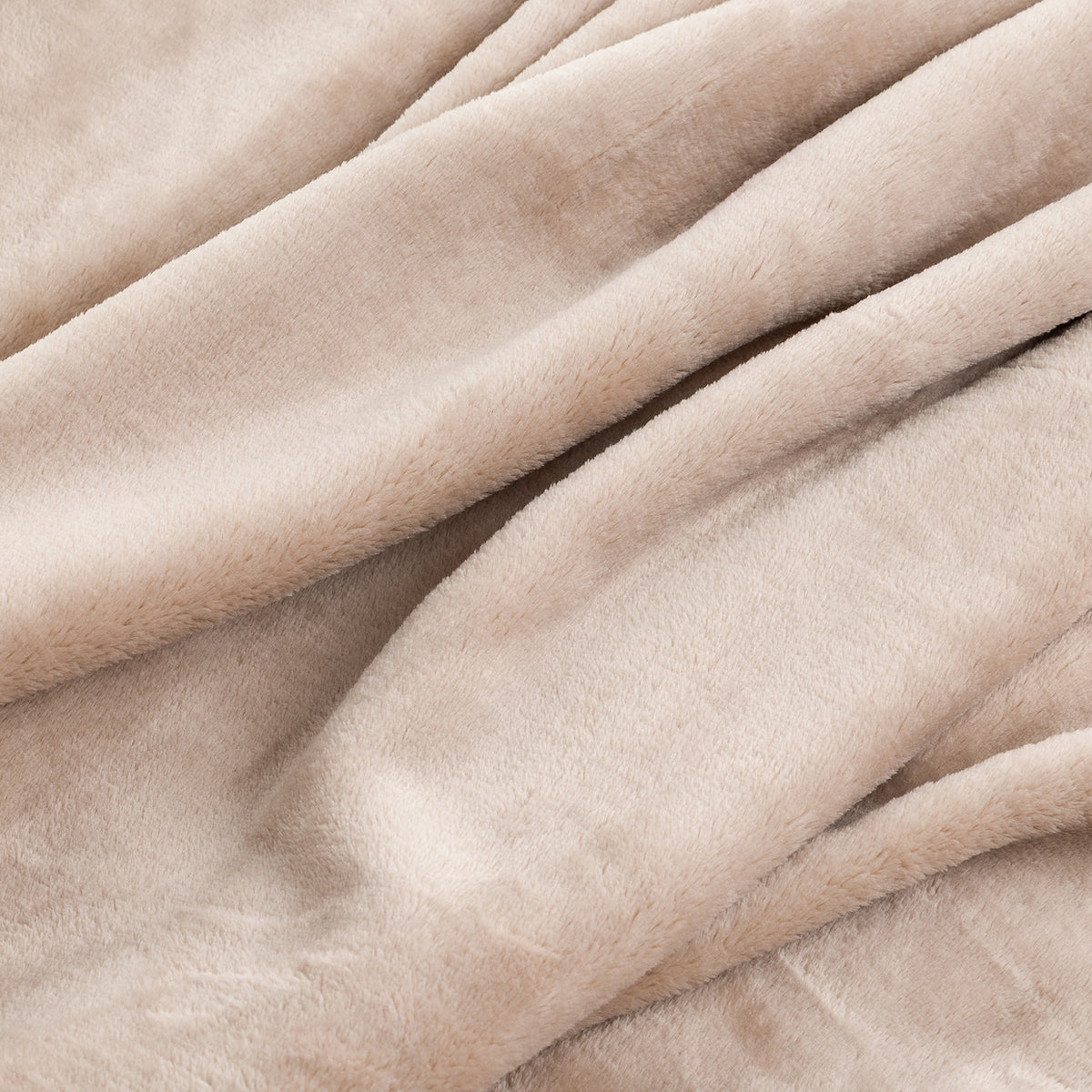 A close-up of draped plush fabric in a soft warm beige or cream tone, showing the texture and folds of the material.