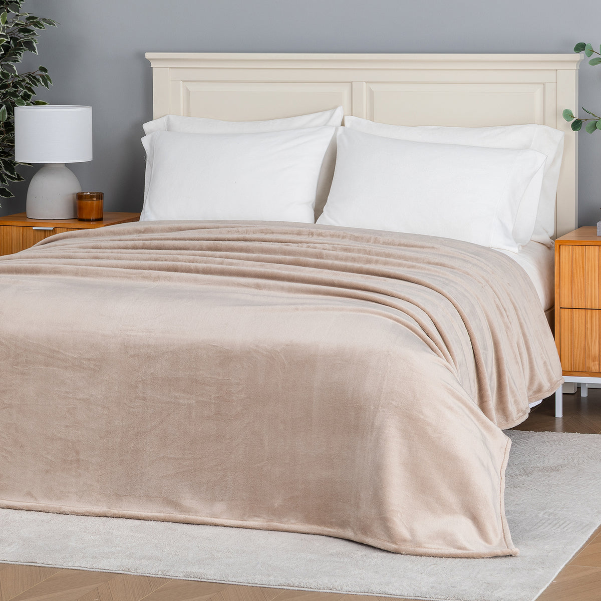 Premium VelvetLoft® Blanket in Hummus on a made bed, angled view