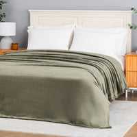 Premium VelvetLoft® Blanket in Ivy on a made bed, angled view