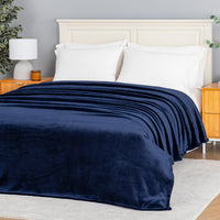 Premium VelvetLoft® Blanket in Midnight Blue on a made bed, angled view