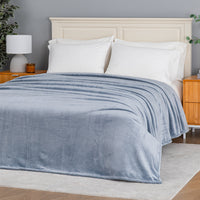 Premium VelvetLoft® Blanket in Polar Blue on a made bed, angled view