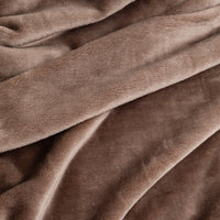 A close-up of draped plush fabric in a warm taupe-brown color, showing the soft texture and folds of the material.