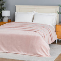 Premium VelvetLoft® Blanket in Rose Smoke on a made bed, angled view