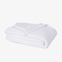 Premium VelvetLoft® Blanket in True White, folded on a white background