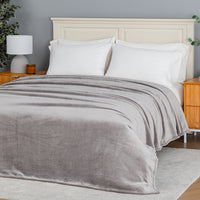 Premium VelvetLoft® Blanket in Wild Dove on a made bed, angled view