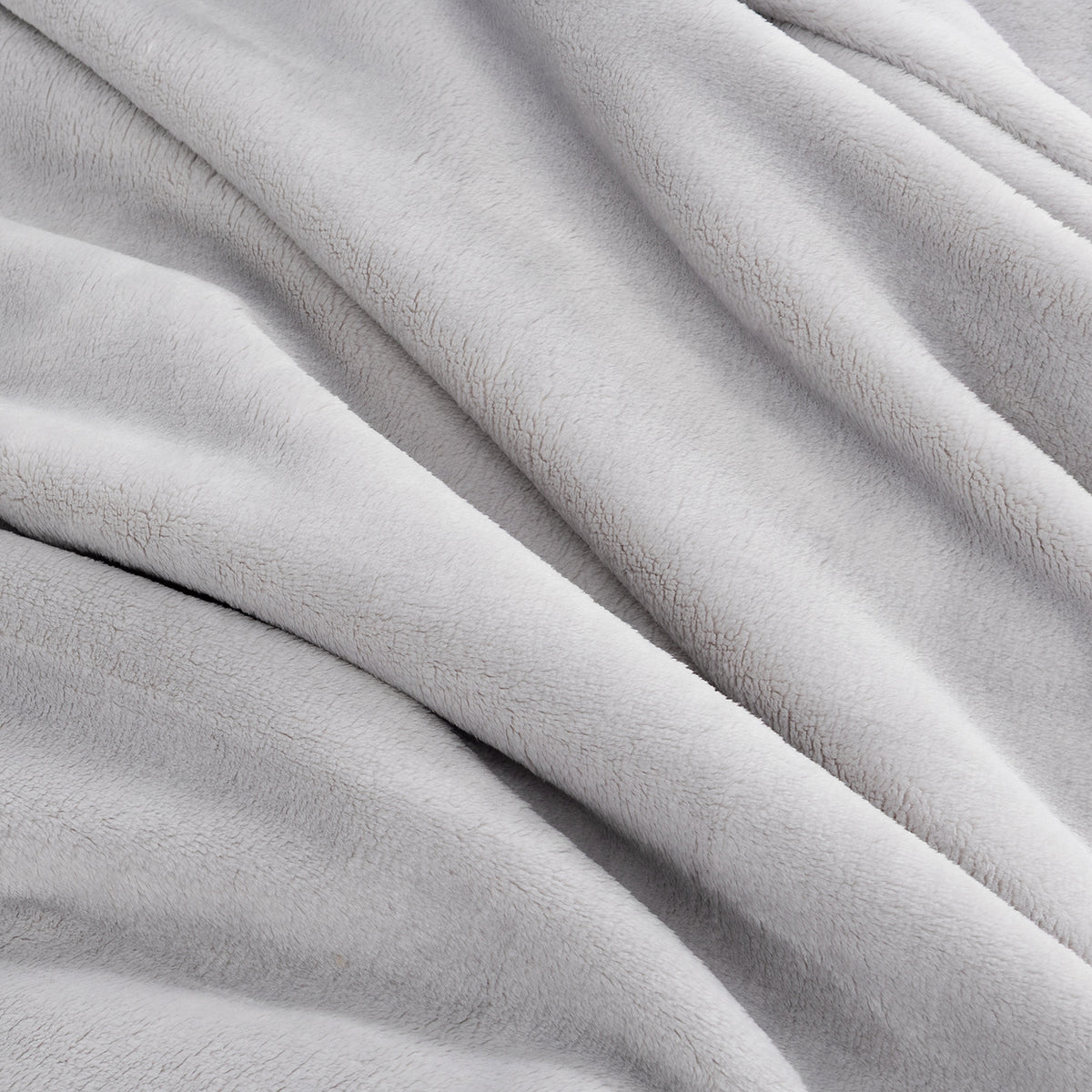 A close-up of a soft, plush fleece blanket in a light gray color, draped in gentle folds.