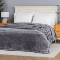 Premium Extra-Fluffy™ Blanket in Amherst Gray spread over a made bed, angled view