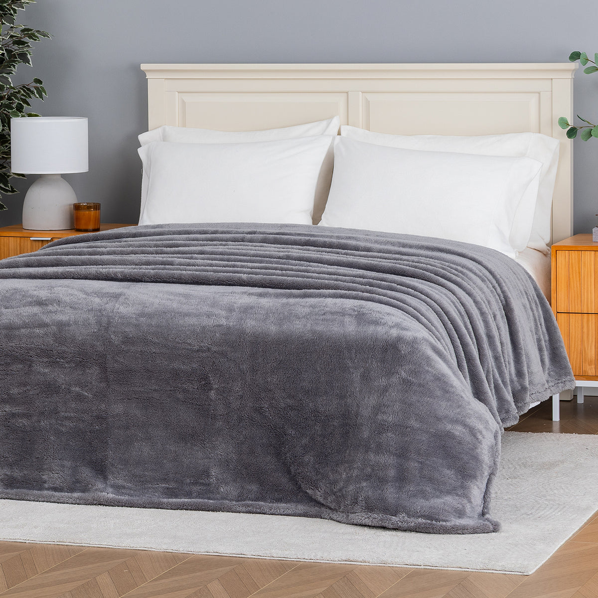 Premium Extra-Fluffy™ Blanket in Amherst Gray spread over a made bed, angled view