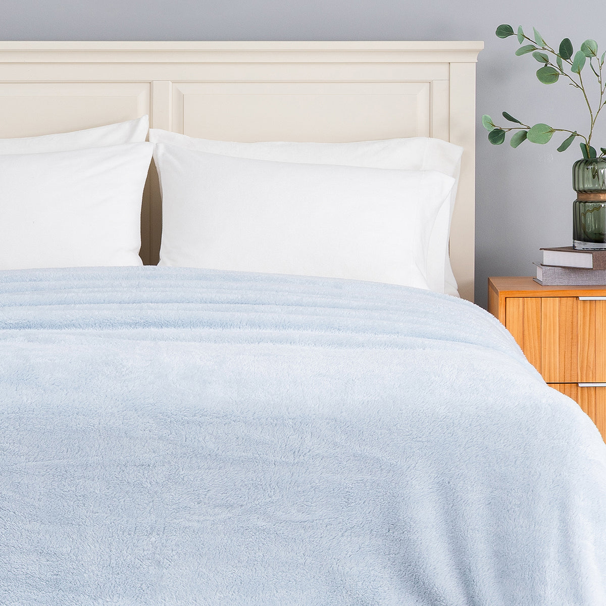 Premium Extra-Fluffy™ Blanket in Arctic Blue turned down at the head of a bed, close view