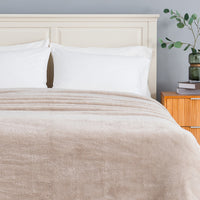 Premium Extra-Fluffy™ Blanket in Grain turned down at the head of a bed, close view