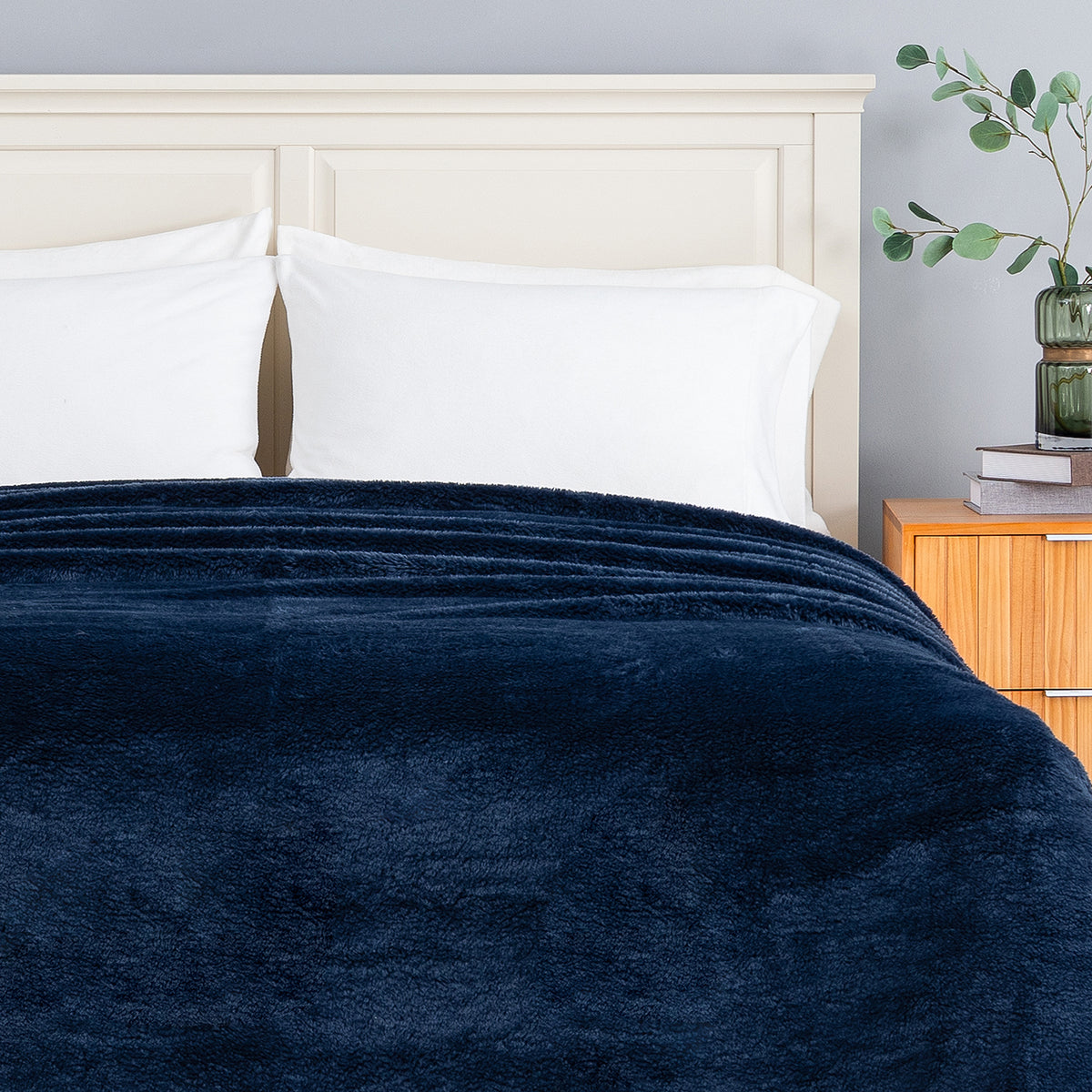 Premium Extra-Fluffy™ Blanket in Historical Blue turned down at the head of a bed, close view