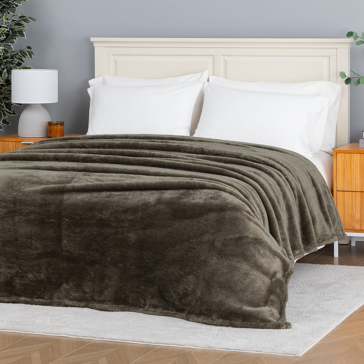 Premium Extra-Fluffy™ Blanket in Kalamata spread over a made bed, angled view