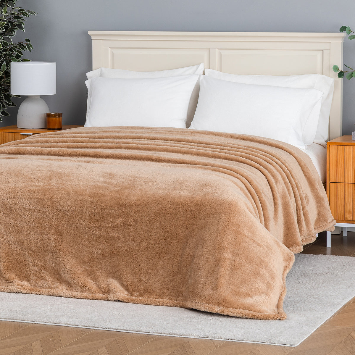 Premium Extra-Fluffy™ Blanket in Prosecco spread over a made bed, angled view