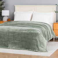 Premium Extra-Fluffy™ Blanket in Rolling Hills spread over a made bed, angled view