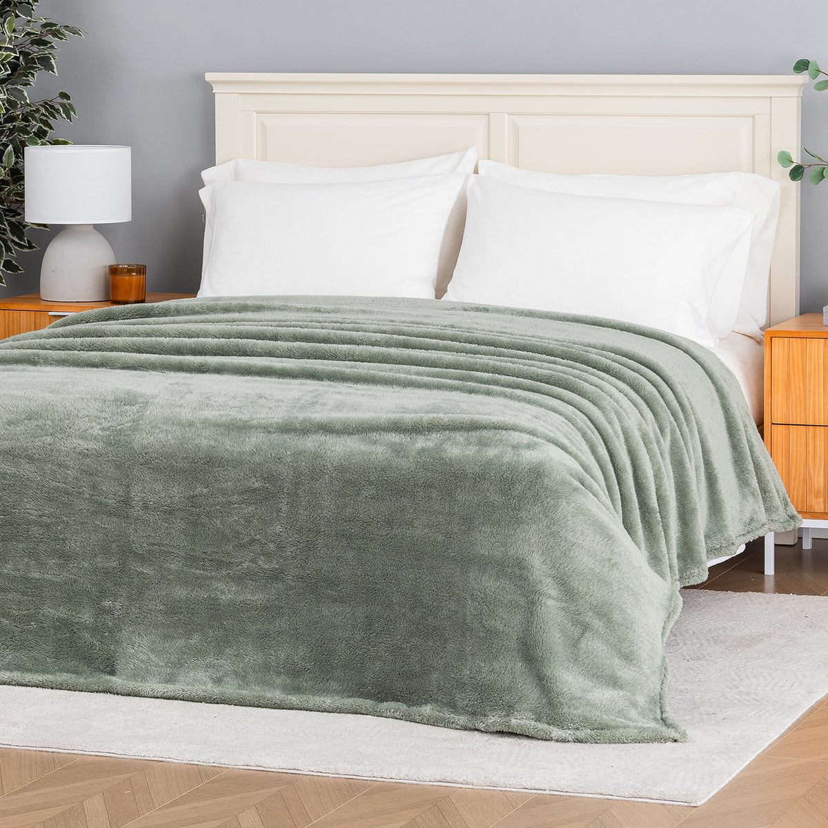 Premium Extra-Fluffy™ Blanket in Rolling Hills spread over a made bed, angled view