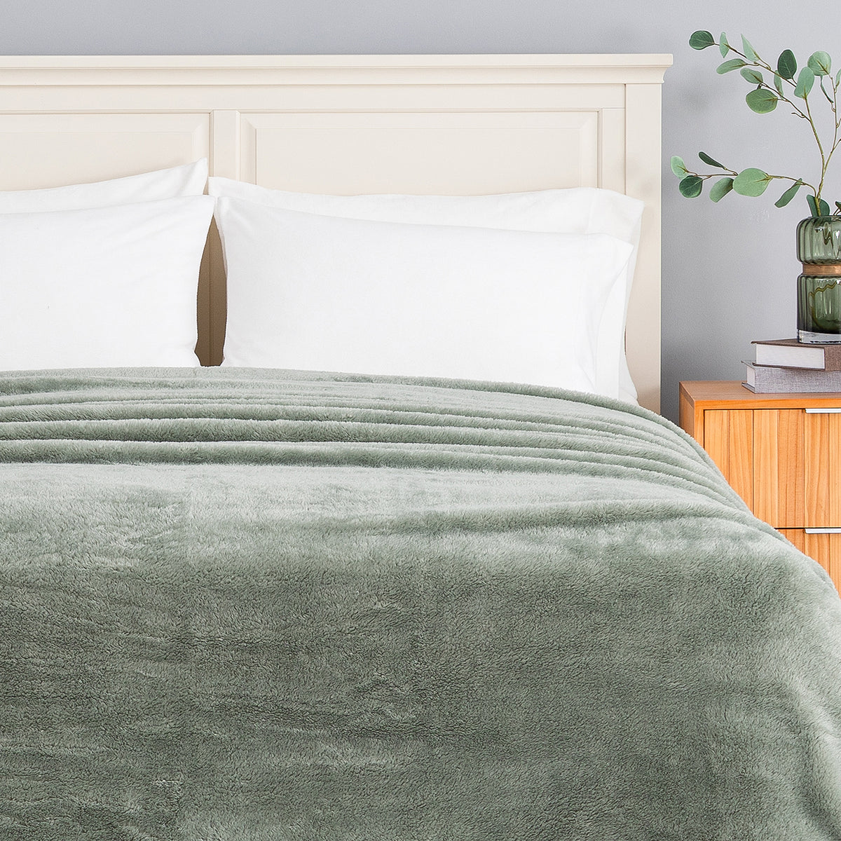 Premium Extra-Fluffy™ Blanket in Rolling Hills turned down at the head of a bed, close view