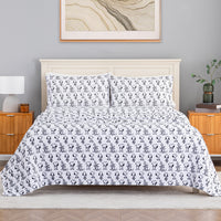 A bed dressed in Peanuts printed VelvetLoft sheets in a modern cozy bedroom.