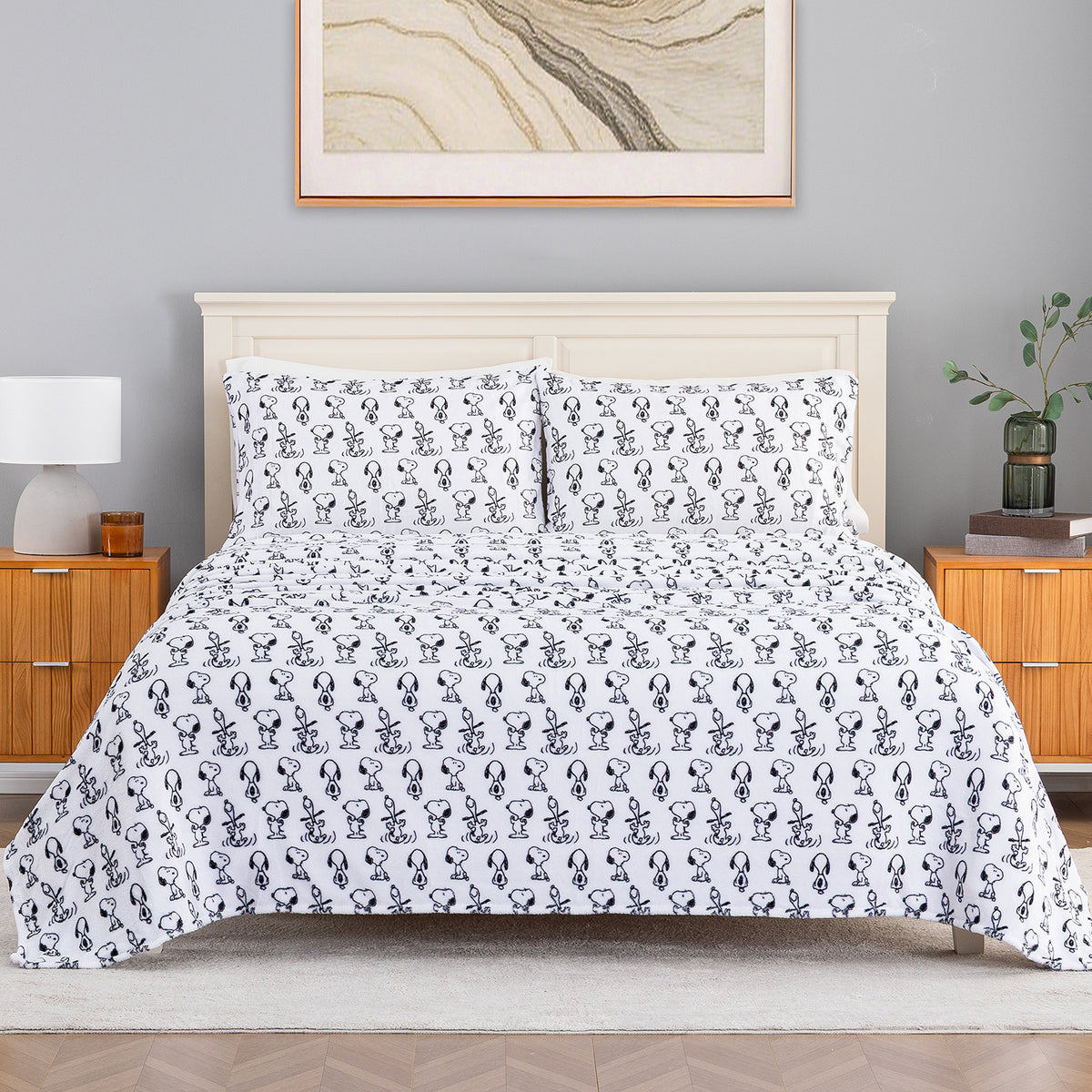 A bed dressed in Peanuts printed VelvetLoft sheets in a modern cozy bedroom.