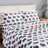 Peanuts holiday printed VelvetLoft sheet set dressed neatly on a bed.