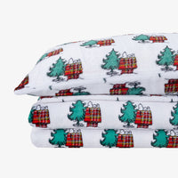 Close up of Peanuts printed VelvetLoft sheet set folded neatly on a white surface.