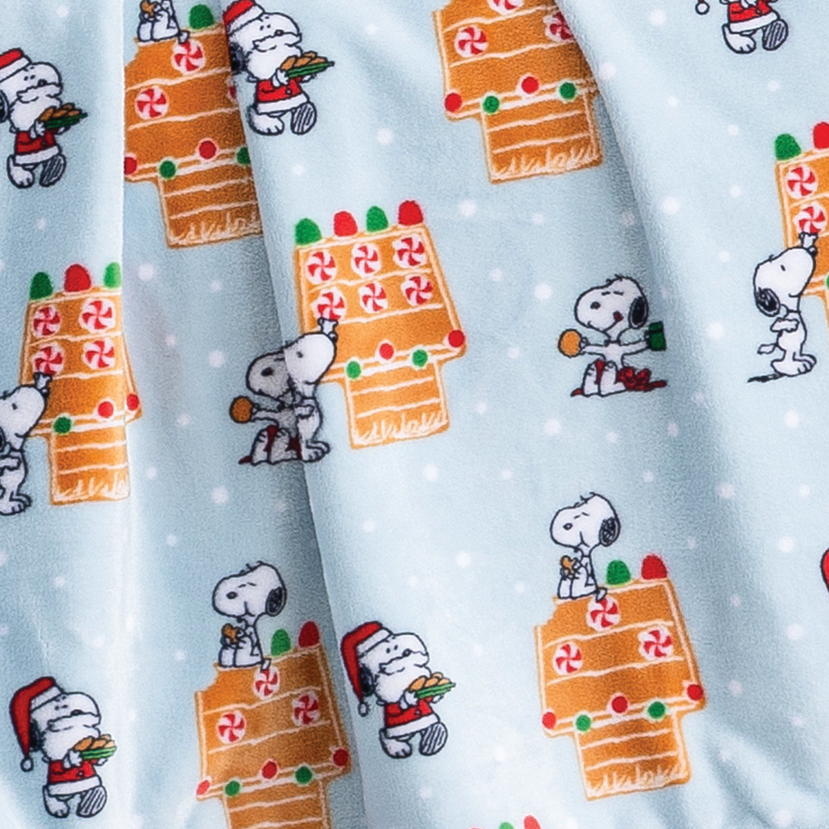 Close up of a blue gingerbread holiday Peanuts Printed VelvetLoft Throw 