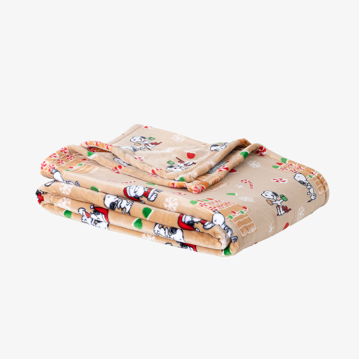 A gingerbread printed holiday Peanuts Printed VelvetLoft Throw folded neatly on a white surface.