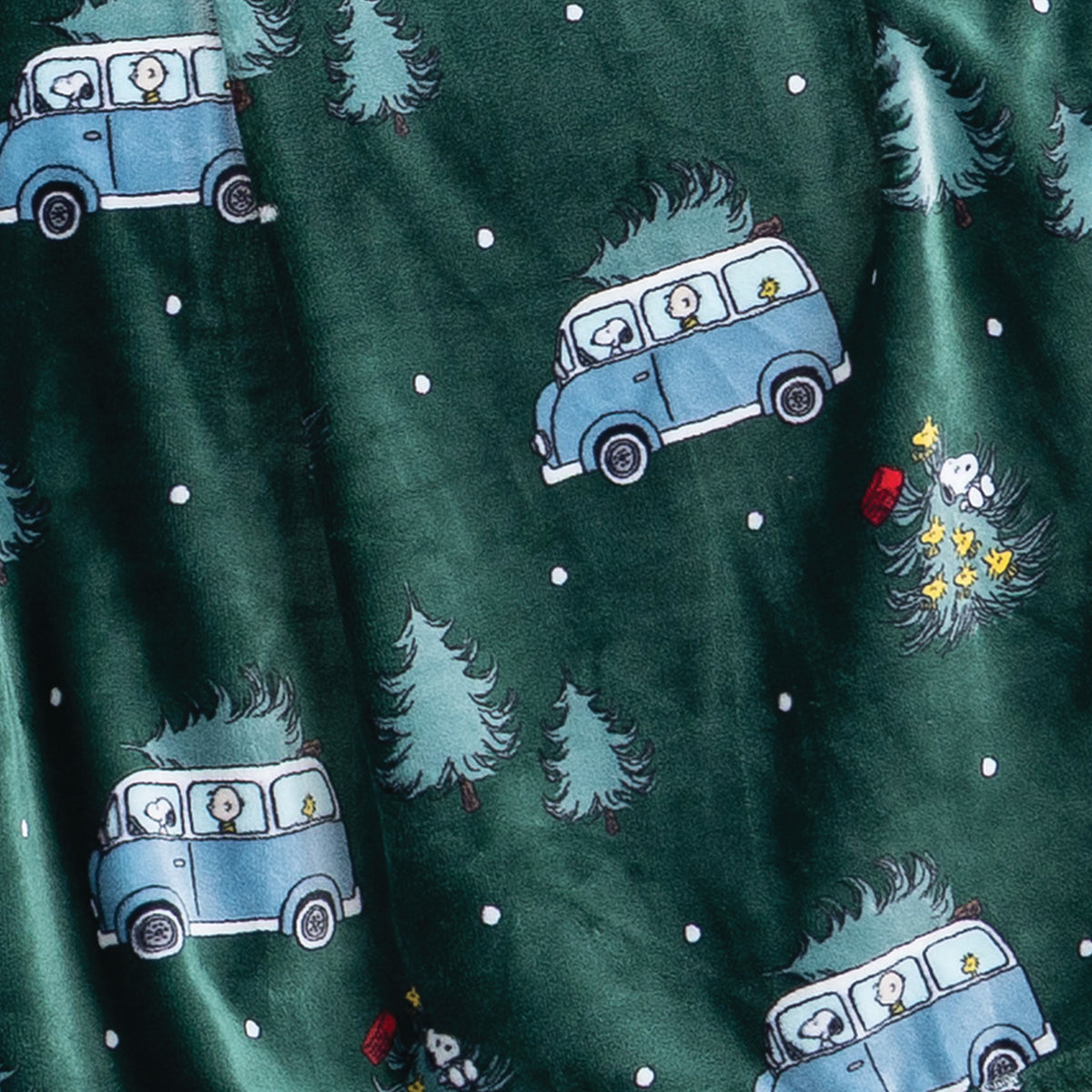 Close up of a green holiday Peanuts Printed VelvetLoft Throw.
