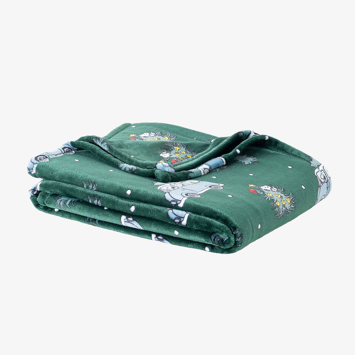 A green holiday Peanuts Printed VelvetLoft Throw folded neatly on a white surface.