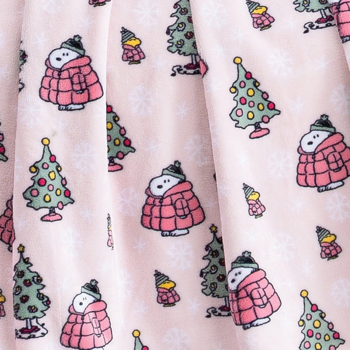 Close up of a pink holiday Peanuts Printed VelvetLoft Throw.