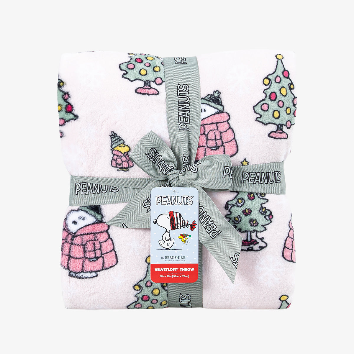 A holiday Peanuts Printed VelvetLoft Throw folded neatly with a ribbon on a white surface.