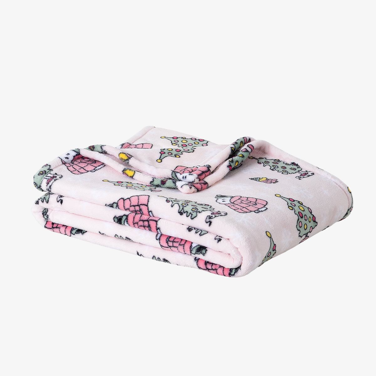 A pink holiday Peanuts Printed VelvetLoft Throw folded neatly on a white surface.