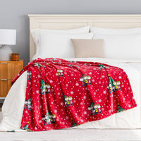 A holiday Peanuts Printed VelvetLoft Throw draped neatly over a bed.