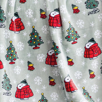Close up of a sage green holiday Peanuts Printed VelvetLoft Throw.
