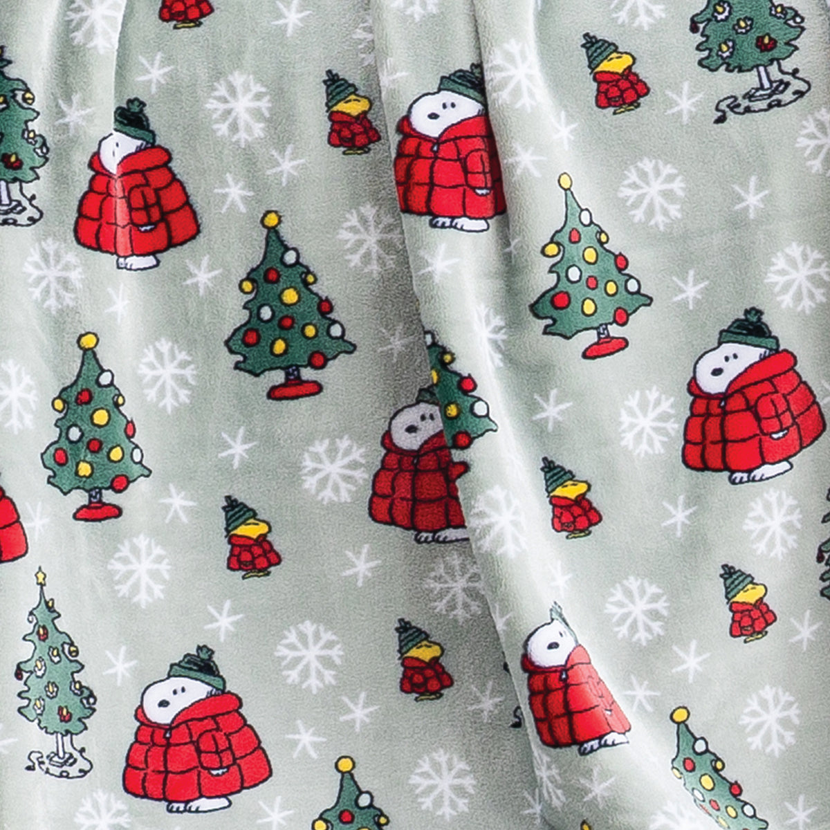 Close up of a sage green holiday Peanuts Printed VelvetLoft Throw.
